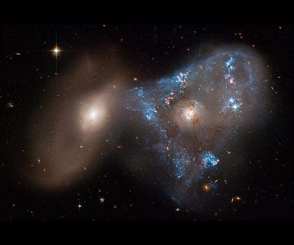 Galaxy collision creates 'space triangle' in new Hubble image