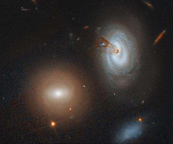 Hubble sees plunging galaxy losing its gas