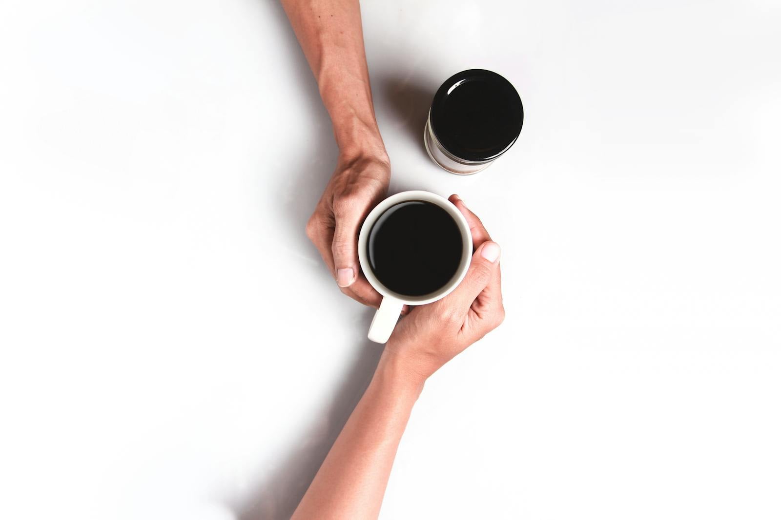 hands holding coffee