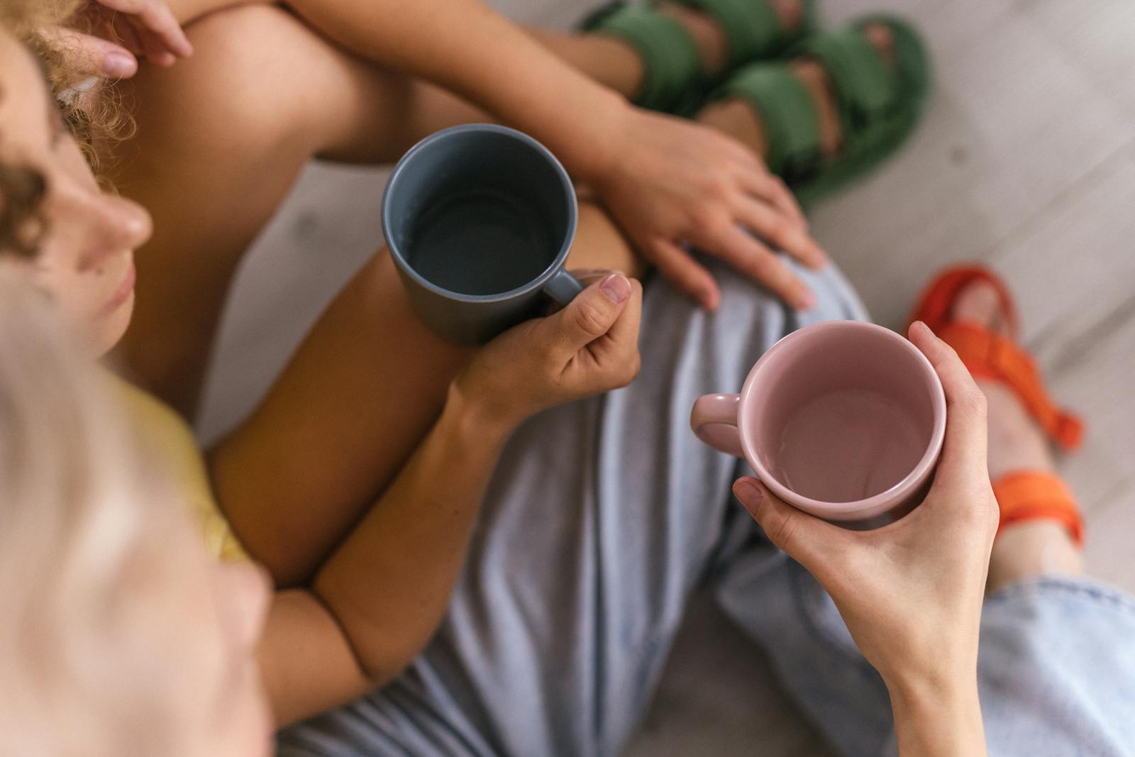 hands passing coffee cup