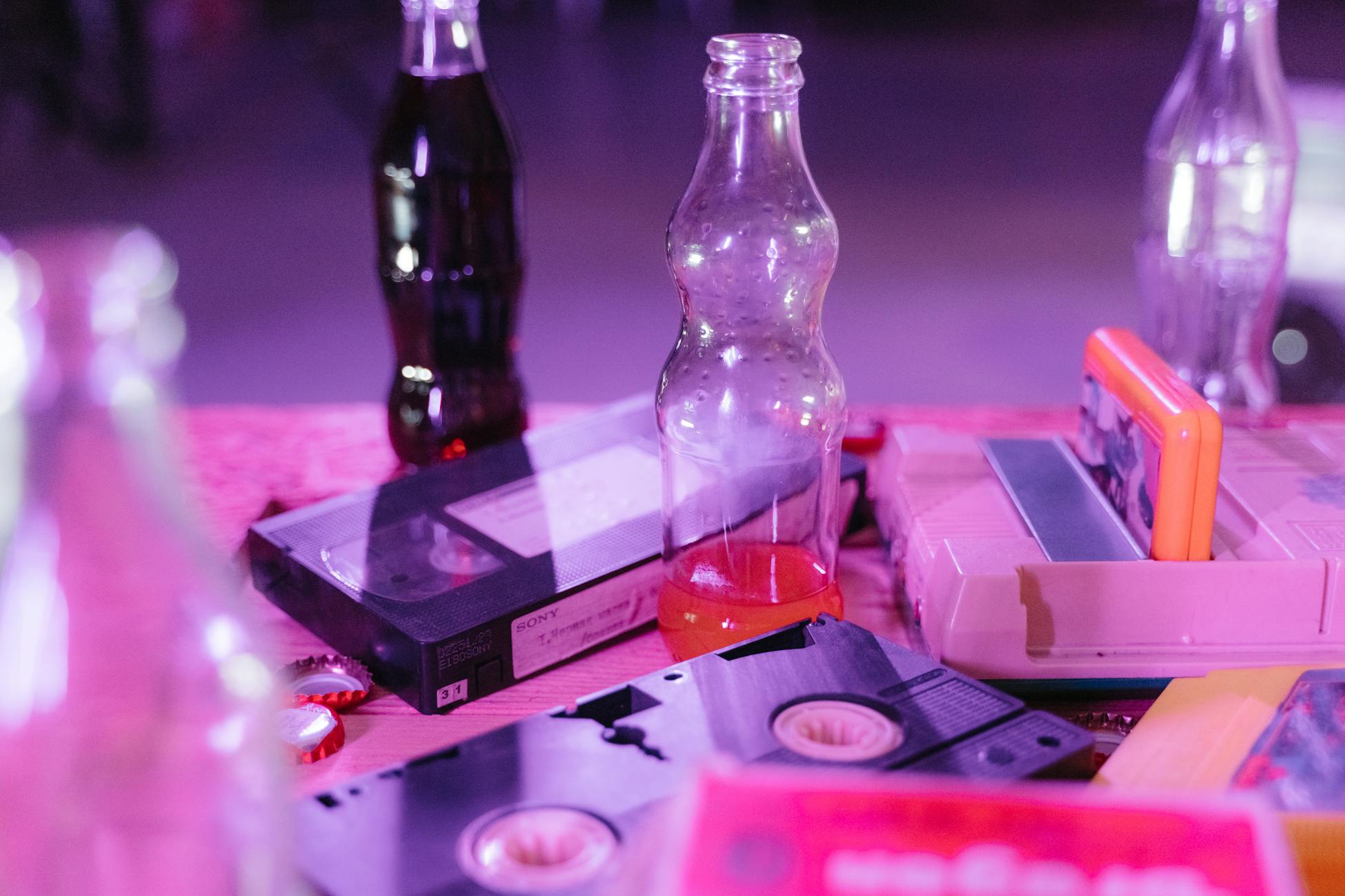 Vintage VHS tapes and colorful soda bottles on display, capturing nostalgia and retro aesthetics.