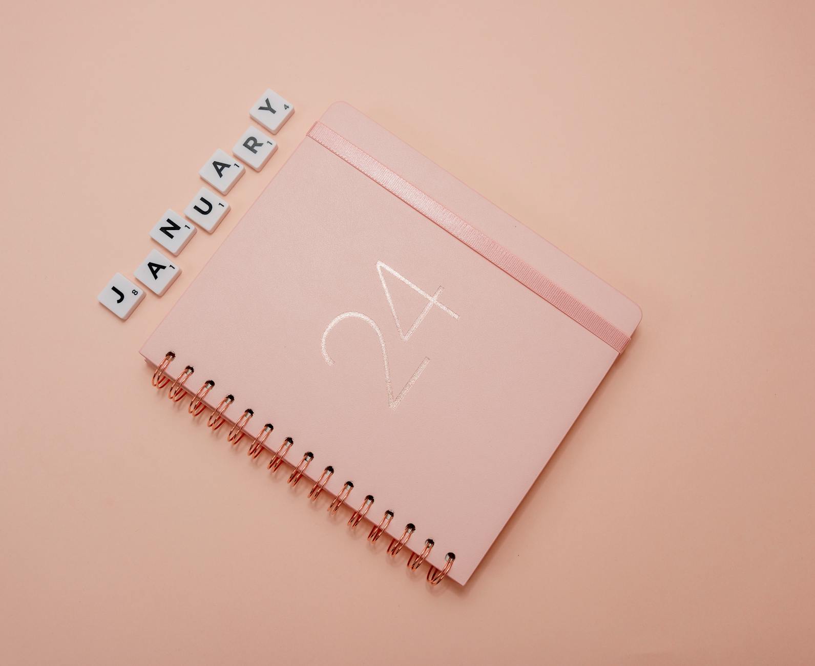 A light pink planner featuring January 24 on a peach background.