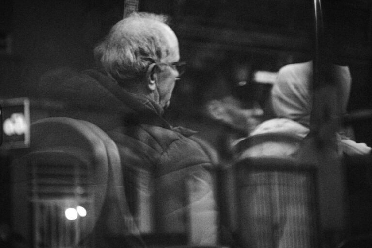 Black and white photo capturing passengers inside a bus in Elche, Spain.