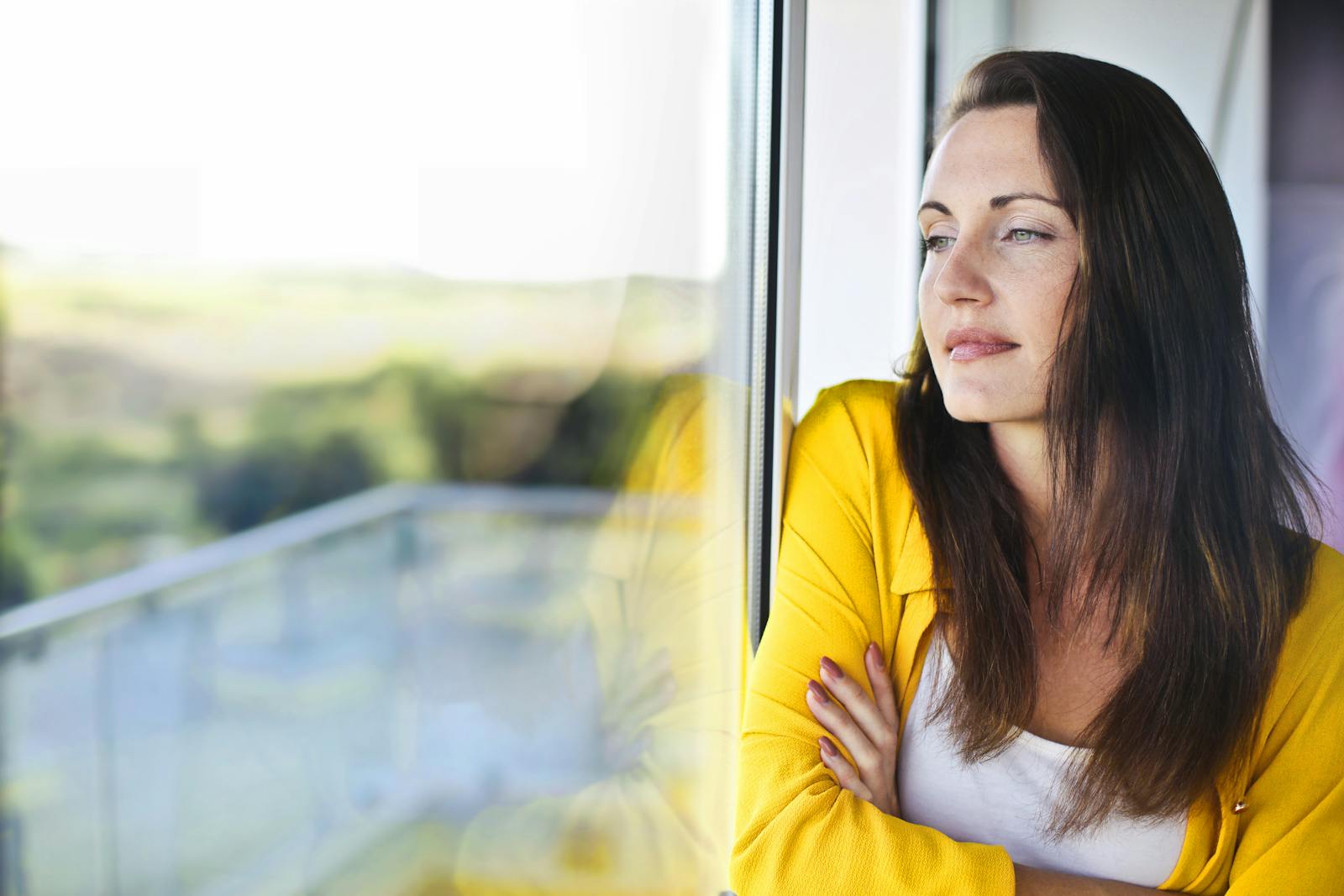woman looking out window thoughtfully