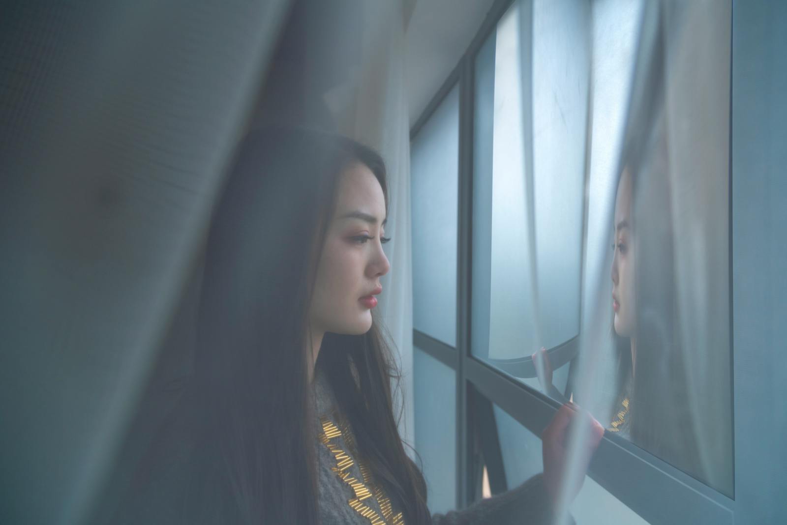 woman looking out window