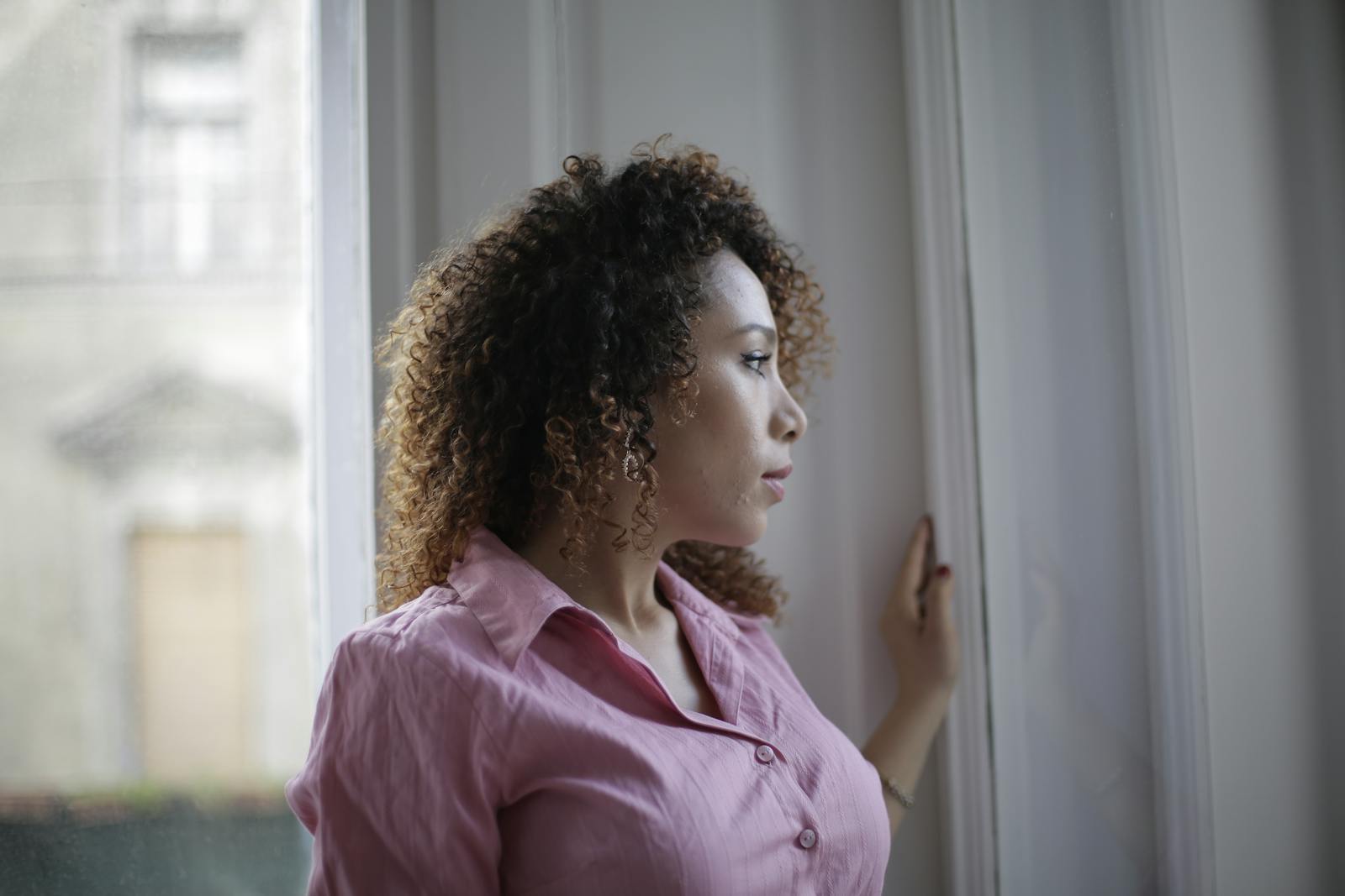 woman thinking quietly window