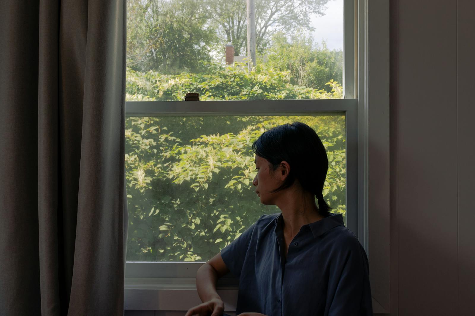 woman thinking window light