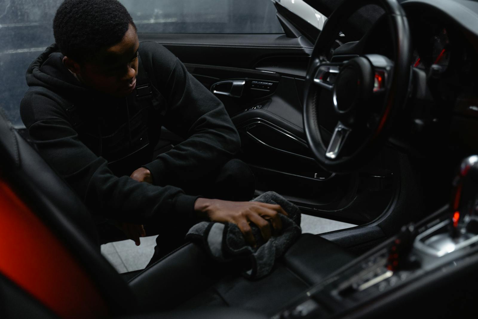hands cleaning steering wheel