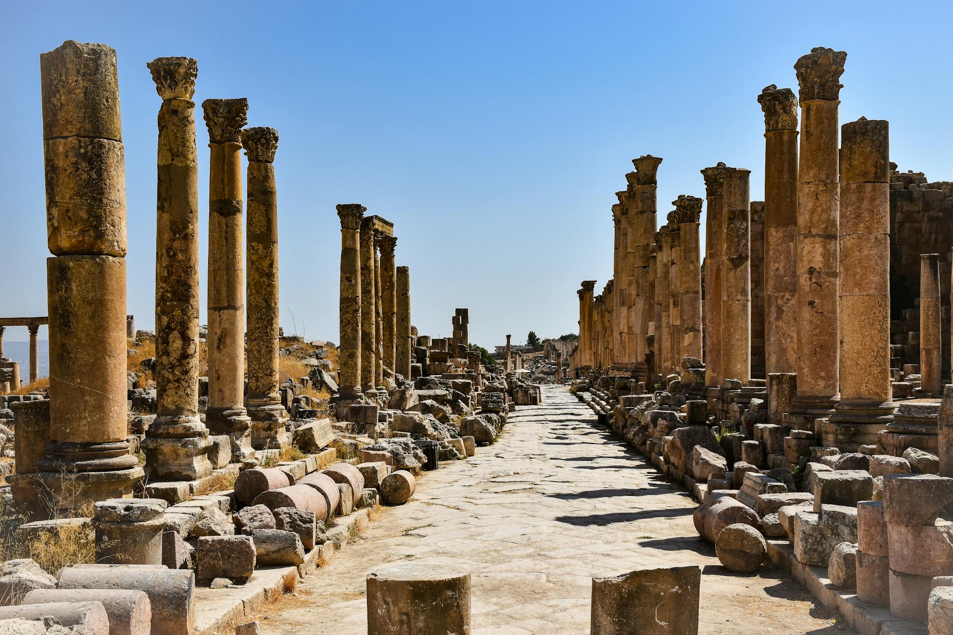 Ruins of ancient Roman columns in Jerash, Jordan, showcasing historical architecture.