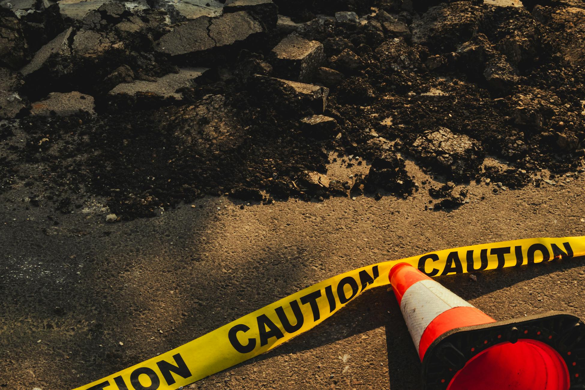 Cracked pavement and smoke in Centralia, Pennsylvania, where underground heat damaged roads and ground surfaces.