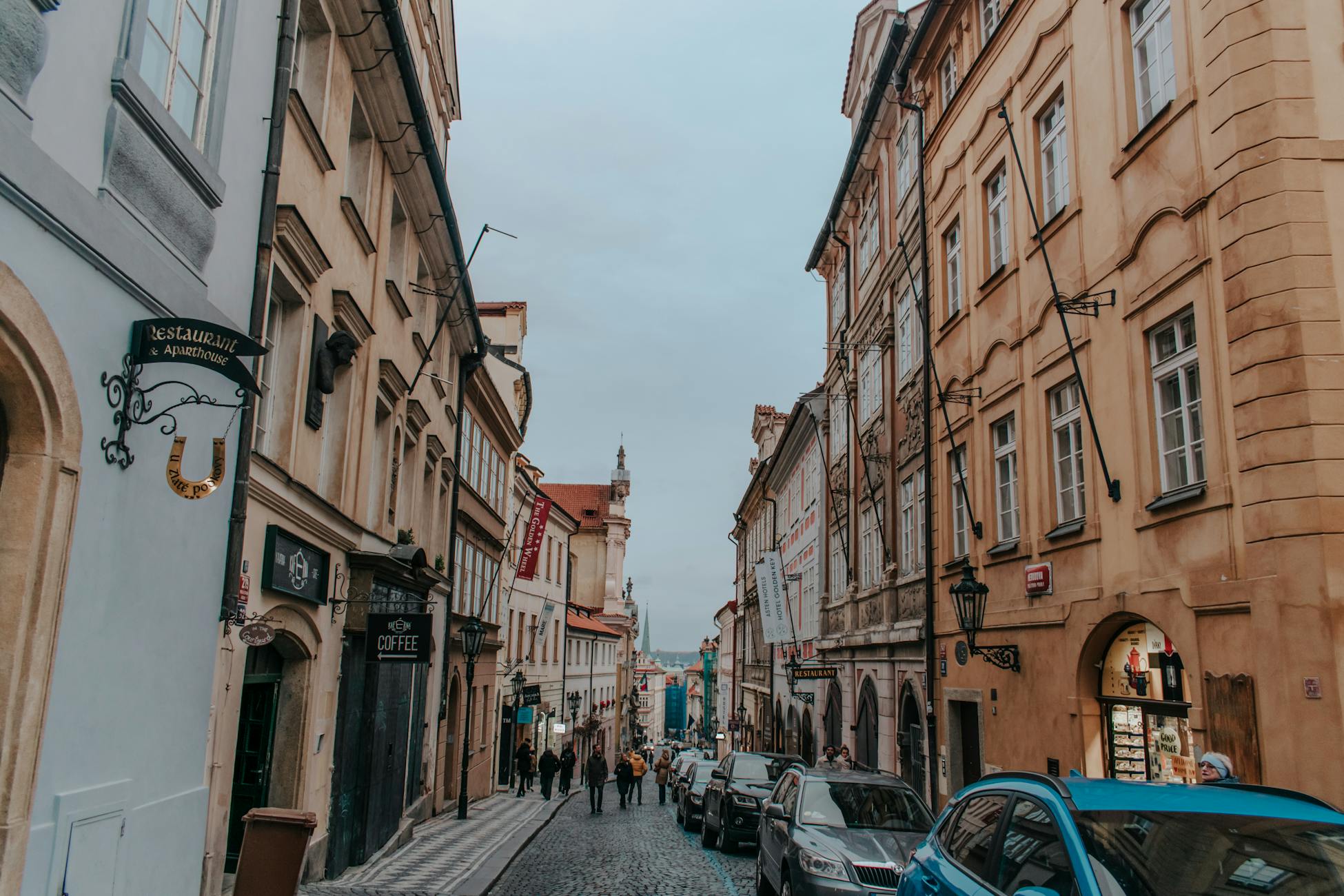 Explore the charm of a historic Prague street with classic architecture and cobblestones.