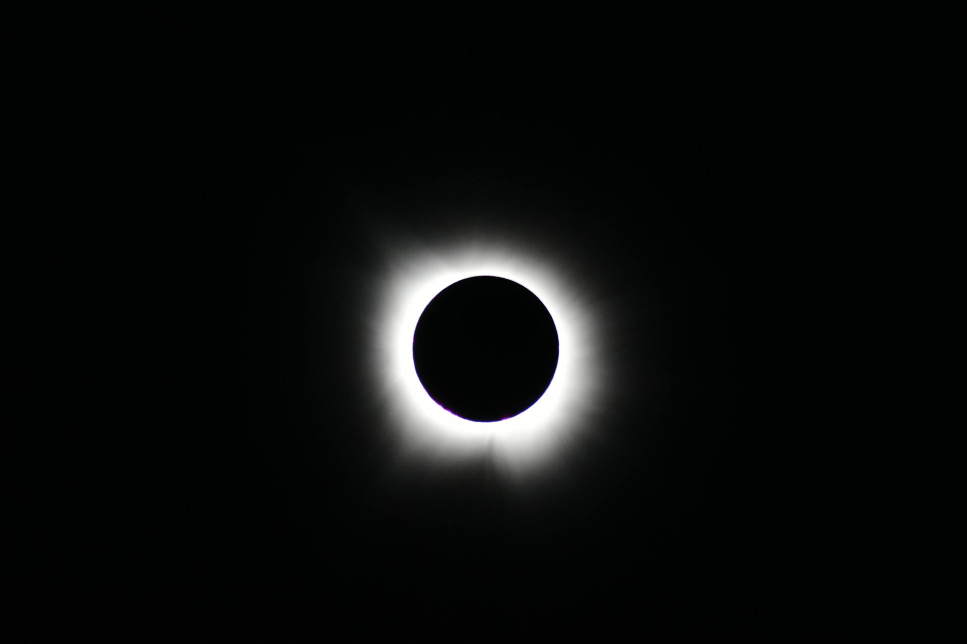 Stunning image of total solar eclipse showing the sun's corona against a dark sky.