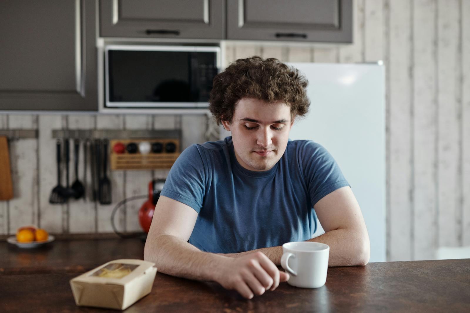 man alone at kitchen table