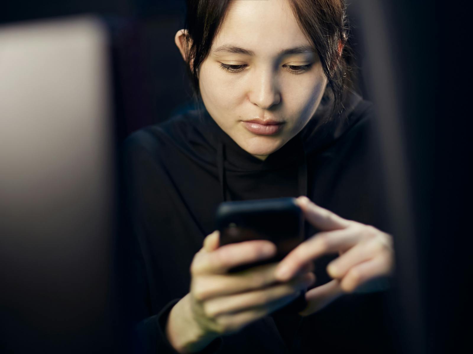 person scrolling phone evening
