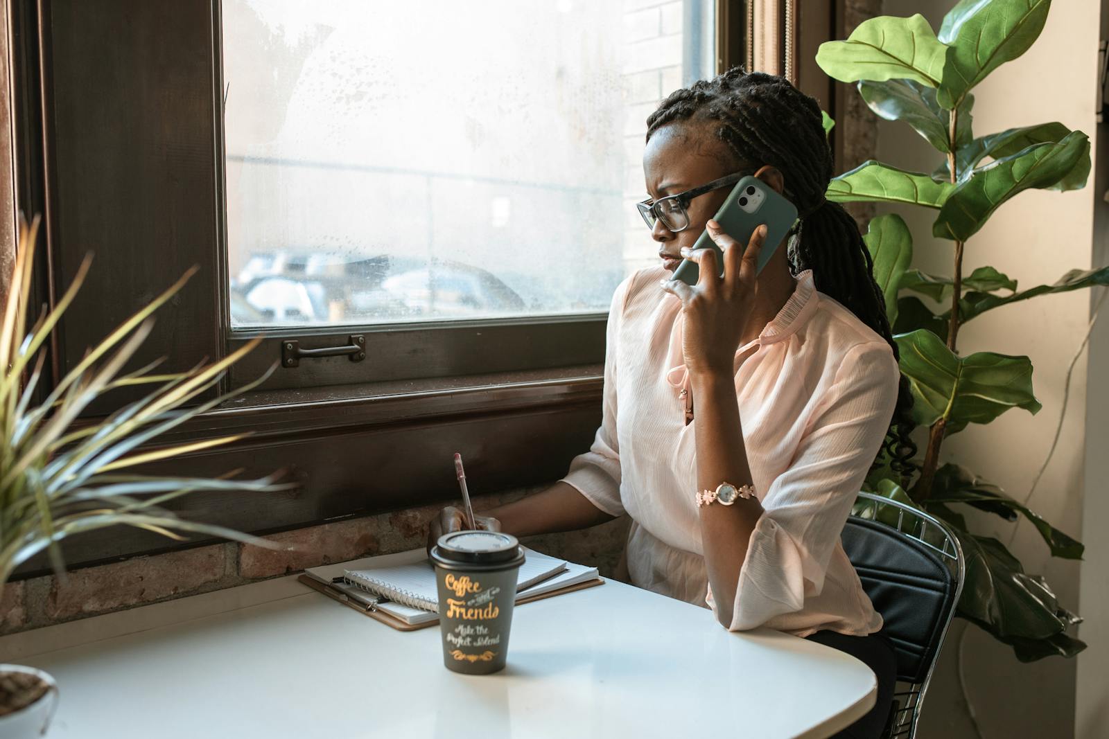 woman talking phone window