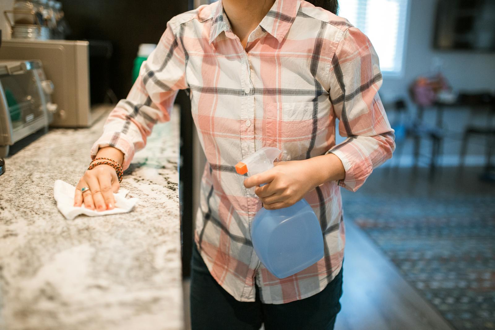 woman wiping kitchen counter