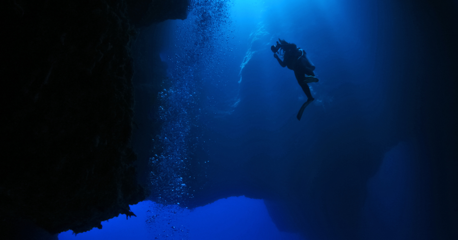 Seven miles beneath the Pacific Ocean, in the deepest place on Earth, American explorer Victor Vescovo descended in 2019 to a depth where the pressure equals 50 jumbo jets stacked overhead — and at the bottom of the Mariana Trench, where no light has ever reached, he found a plastic bag and several candy wrappers waiting on the seabed.