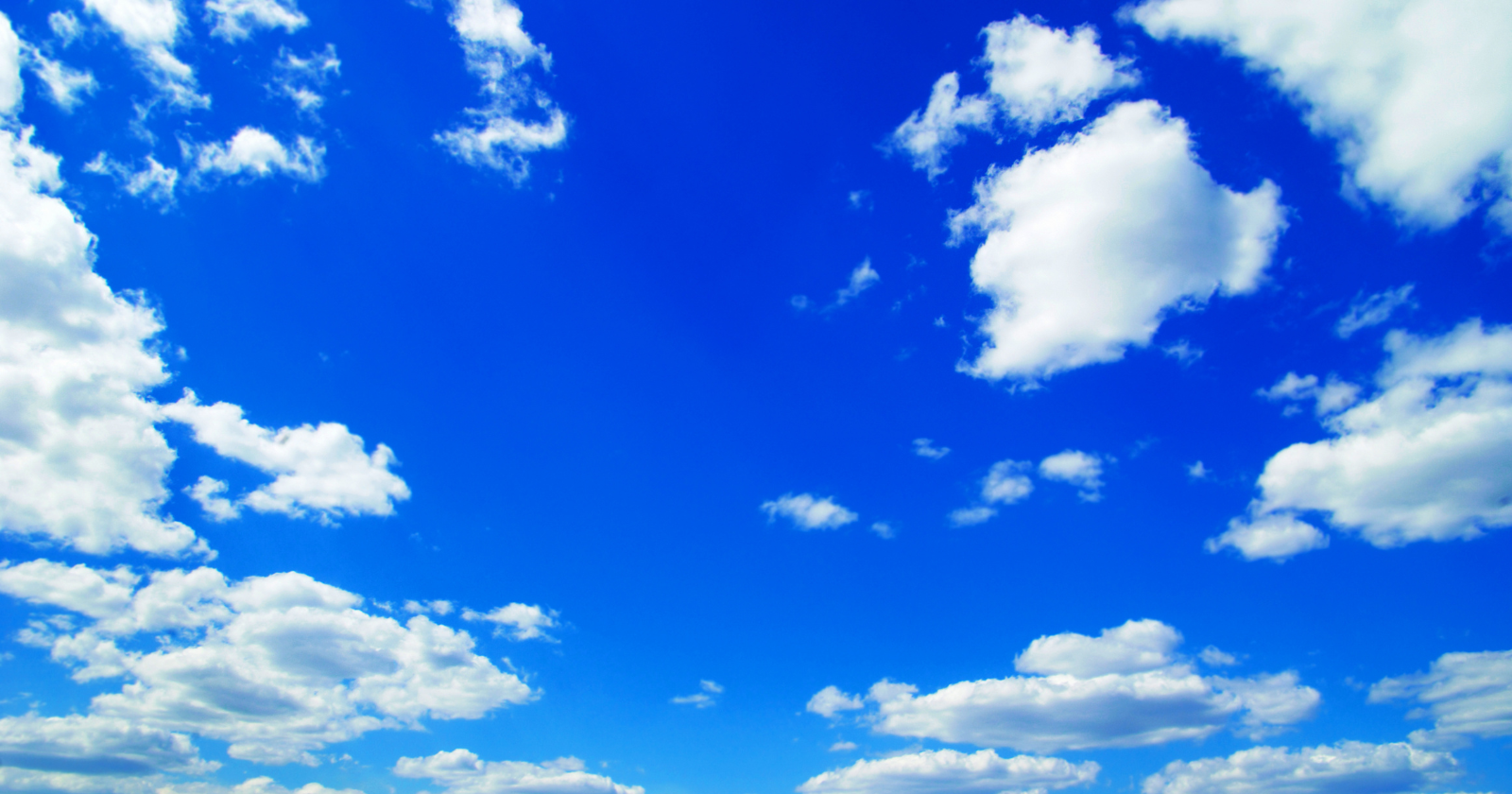 The blue color of the sky is not a property of the air itself — air is colorless, and a glass of it would look exactly like a glass of nothing — and the blue you see overhead is sunlight being scattered by molecules of nitrogen and oxygen, which deflect short blue wavelengths much more strongly than long red ones, in the same physics that makes the Sun appear yellow and a sunset appear red
