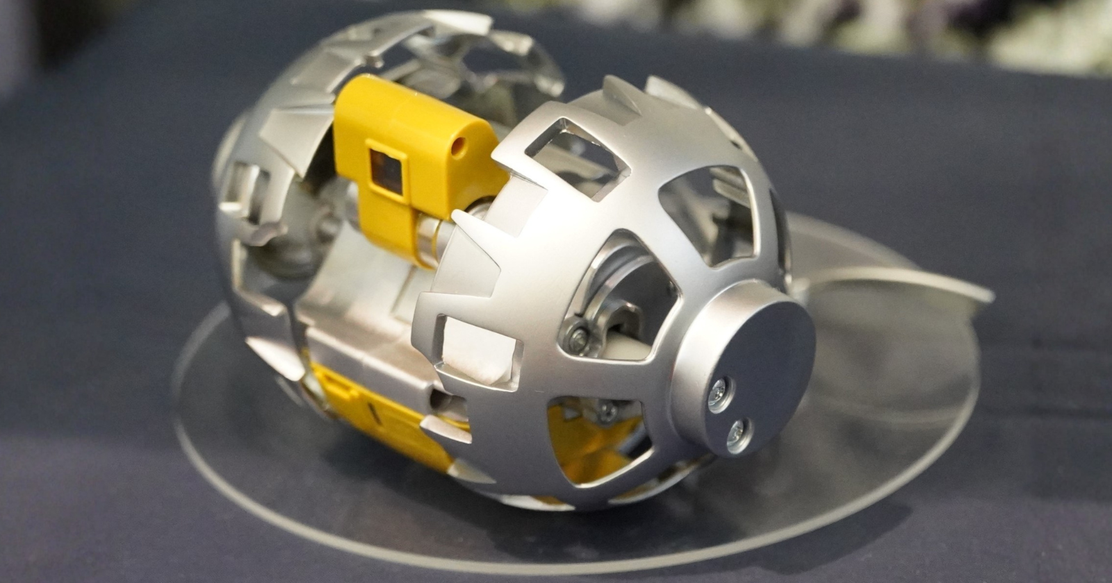 When JAXA engineers needed a self-deploying transformation mechanism small enough to survive a lunar landing inside a metal sphere, they called the Japanese toy company behind the original 1984 Transformers line — and the robot that emerged, eight centimeters across, spent 100 minutes rolling across the Moon in January 2024 and quietly rewrote what a machine the size of a tennis ball can do on another world