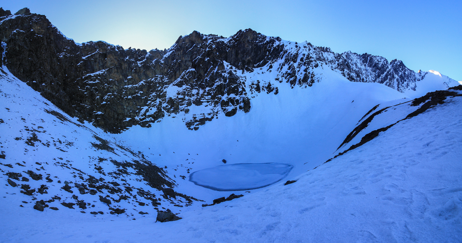 The hundreds of human skeletons scattered around Roopkund Lake at 5,029 metres in the Indian Himalayas were long assumed to be the remains of a single 9th-century pilgrimage group killed by a sudden hailstorm, in an explanation that a 2019 peer-reviewed ancient DNA study has substantially overturned, by demonstrating that the skeletons came from at least three different populations and died across more than one thousand years.
