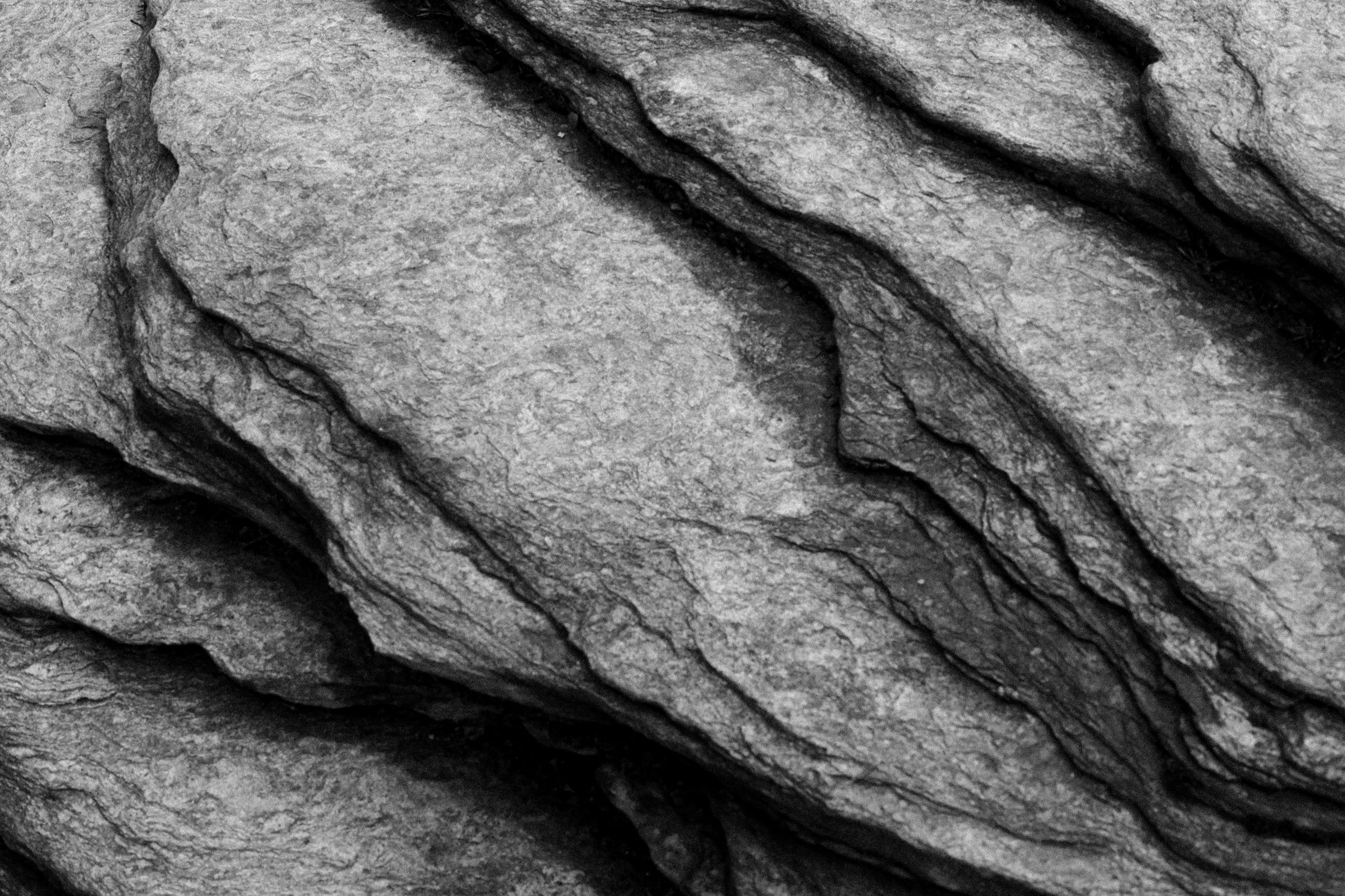 Detailed close-up of layered rock formation, showcasing natural texture.