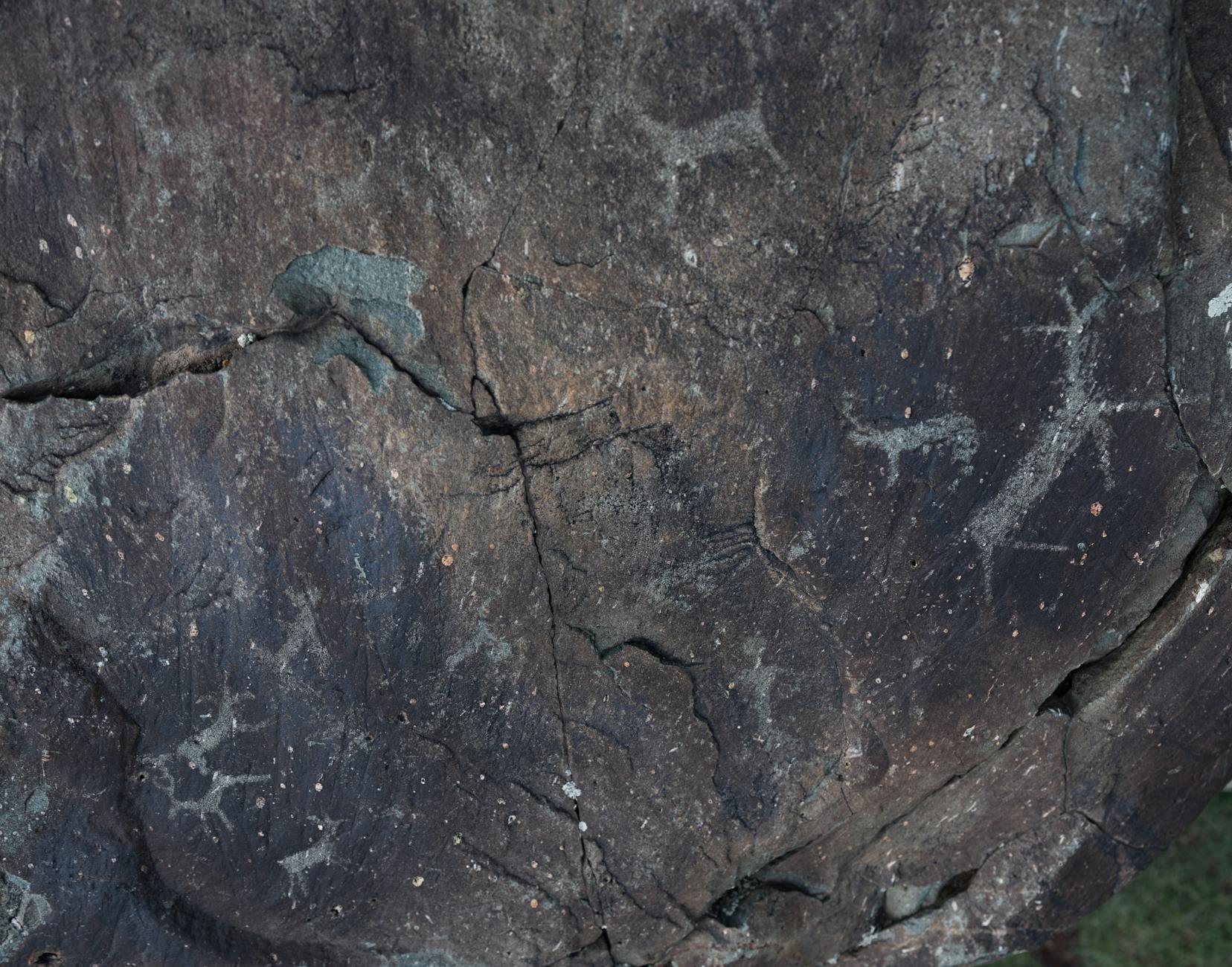 From above of dark gray natural slope with shabby surface and tiny aged paintings
