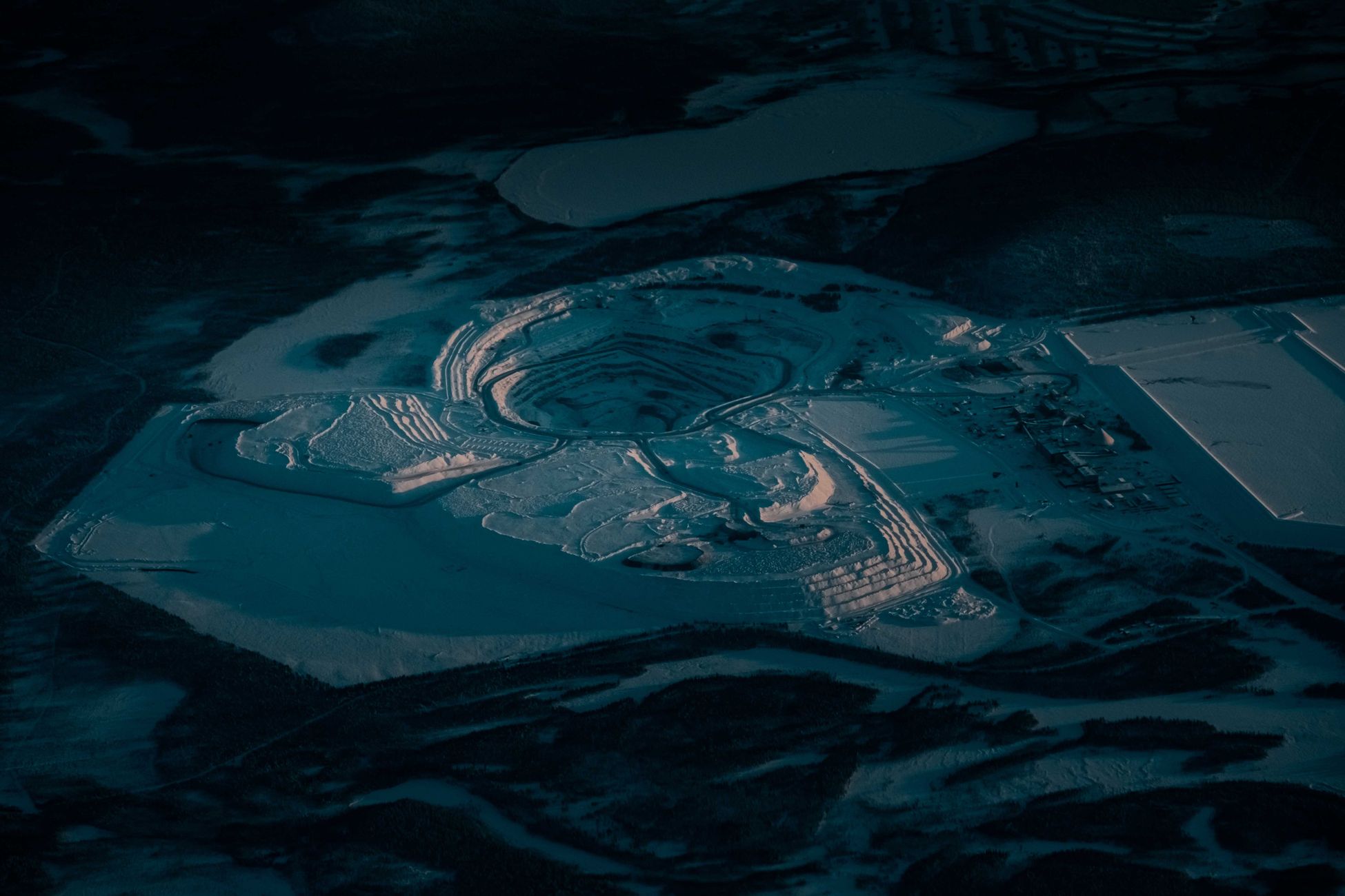 From above of sand pit with dry uneven surface and wavy traces in twilight