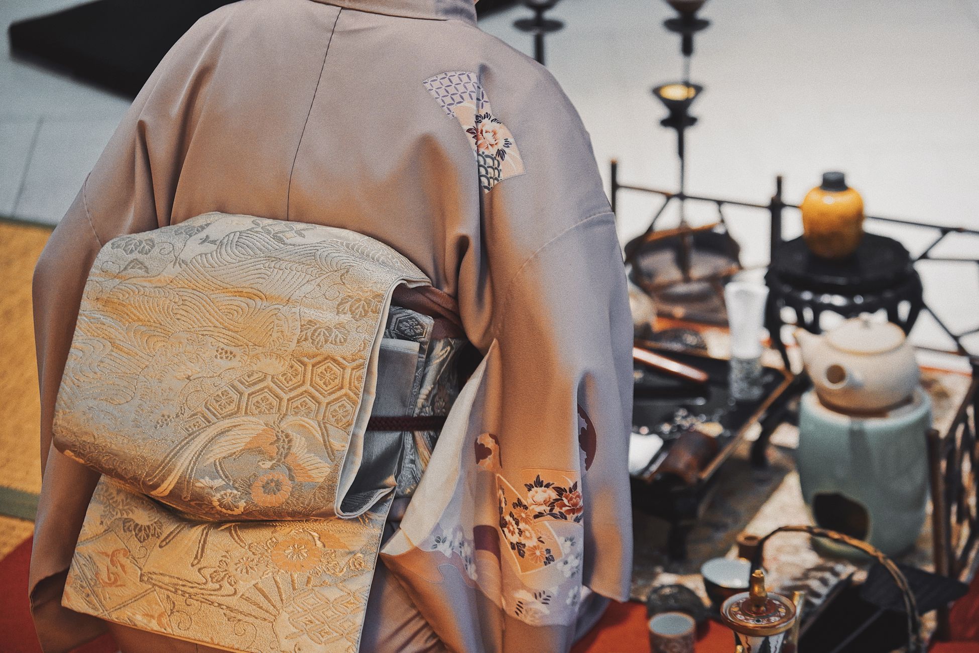 Close-up of a traditional kimono and tea ceremony set, emphasizing Japanese culture and tradition.