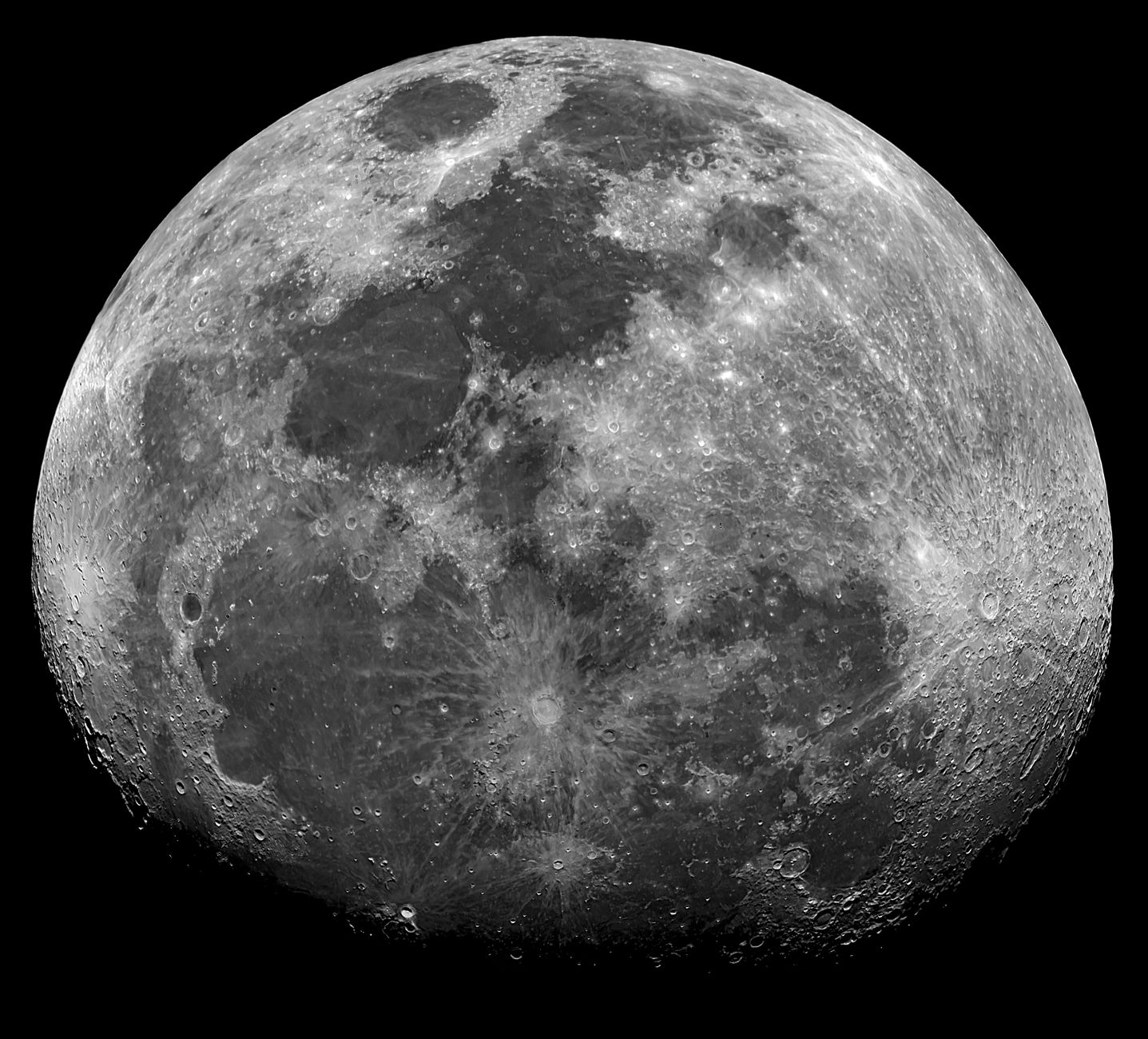 Black and white image of the detailed surface of the moon showing craters and textures.