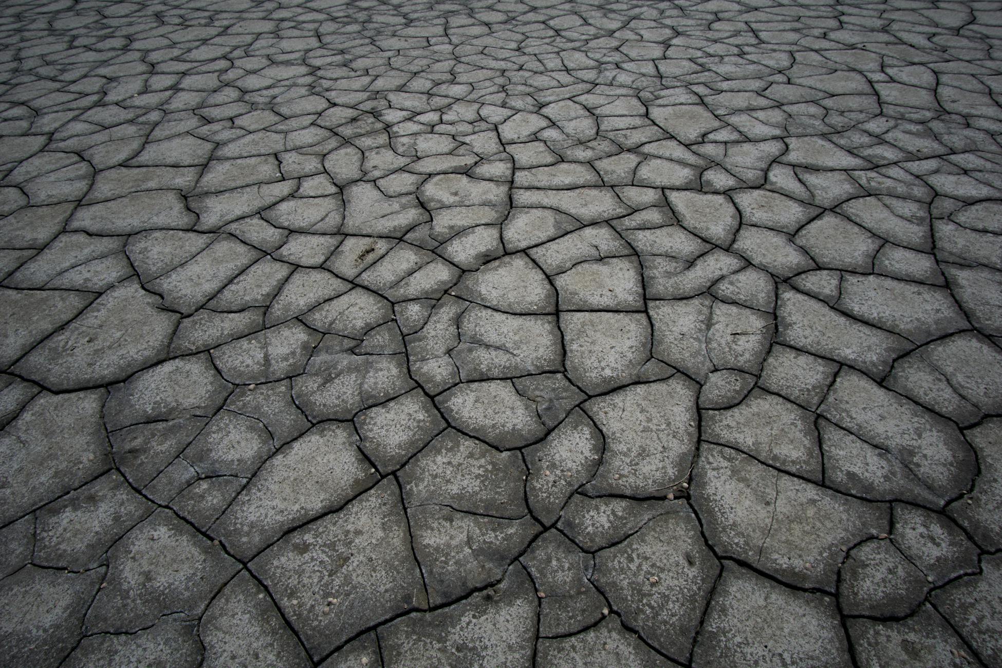 Aerial view of cracked, dry land symbolizing drought and climate impact.