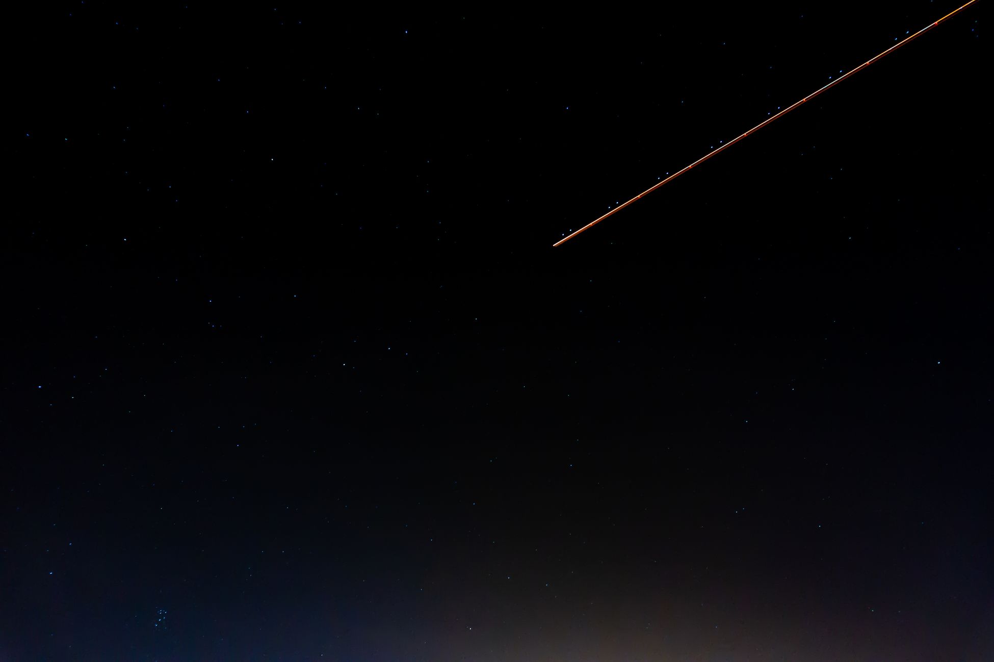 A serene night sky with a shooting star and numerous stars over Kénitra, Morocco.