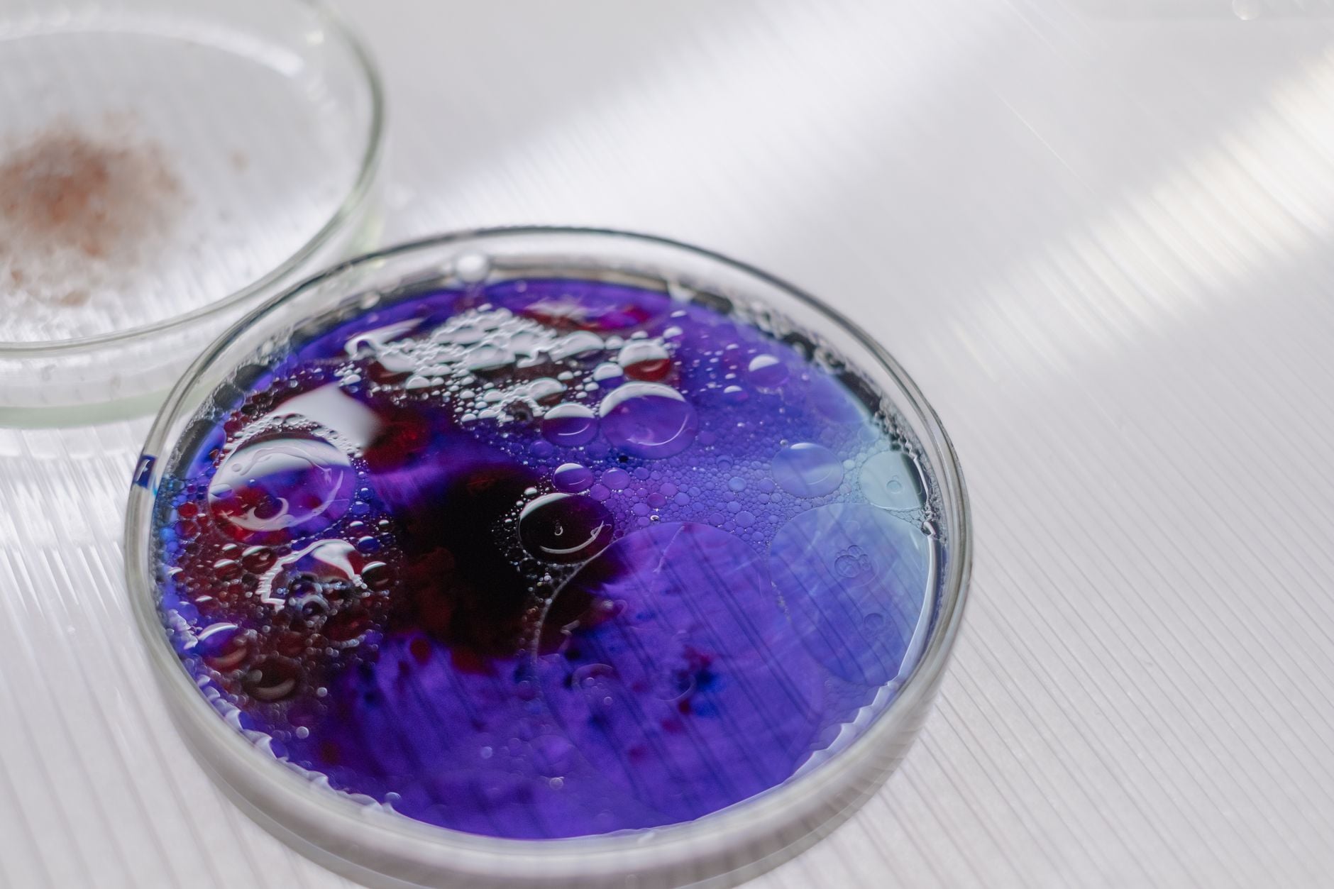 A McMaster University AI model called SyntheMol-RL designed a new antibiotic candidate by searching a chemical space of 46 billion possible compounds — a scale far beyond physical lab screens, which usually test hundreds of thousands to a few million molecules.