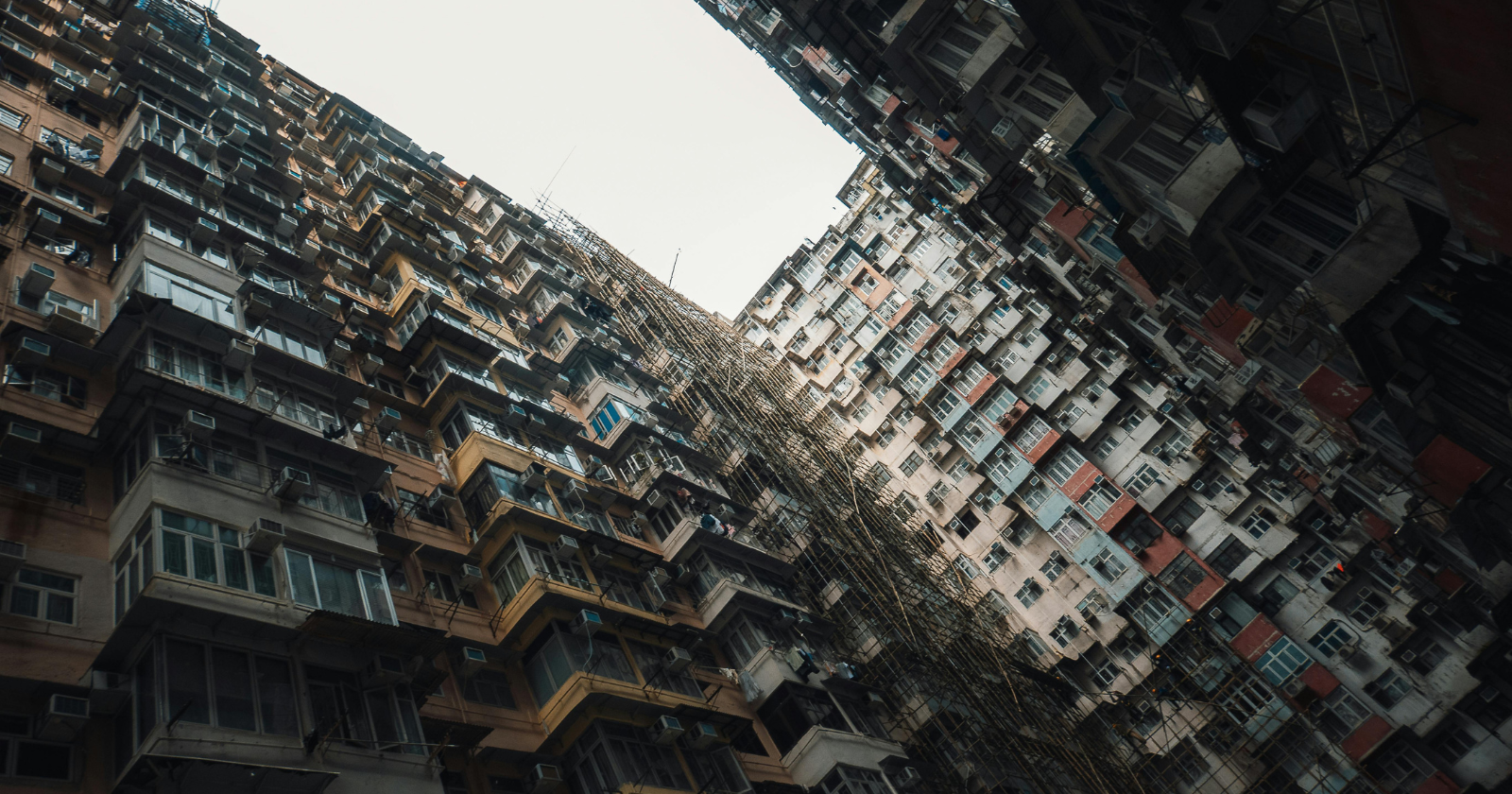 The densest place that has ever been measured on Earth was a single Hong Kong block where 33,000 people lived stacked in six and a half acres — a self-built maze of 350 towers raised without a single architect, so tightly packed that sunlight never reached the lowest floors