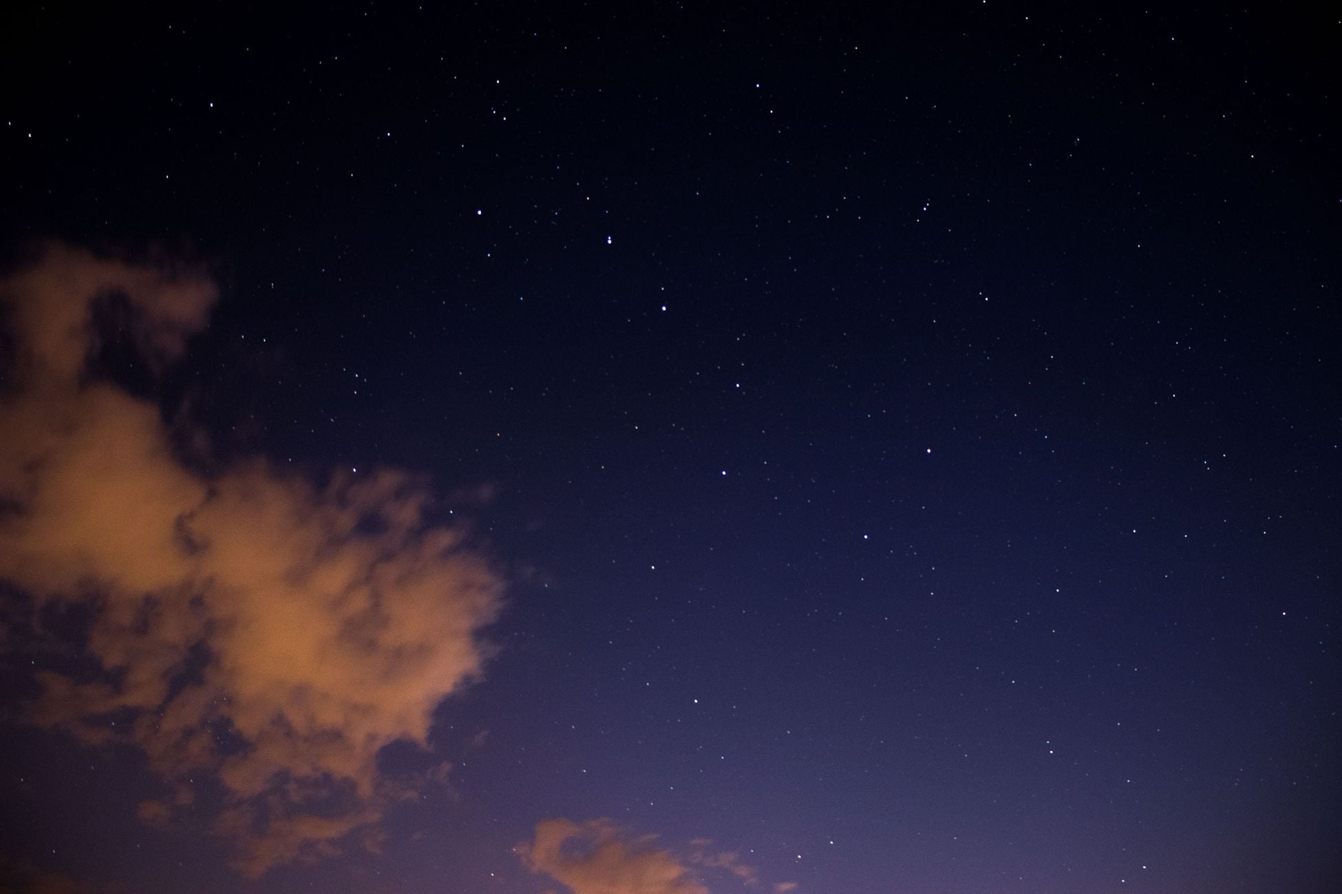 Beautiful starry night sky with soft clouds visible from Mönchberg, Germany.