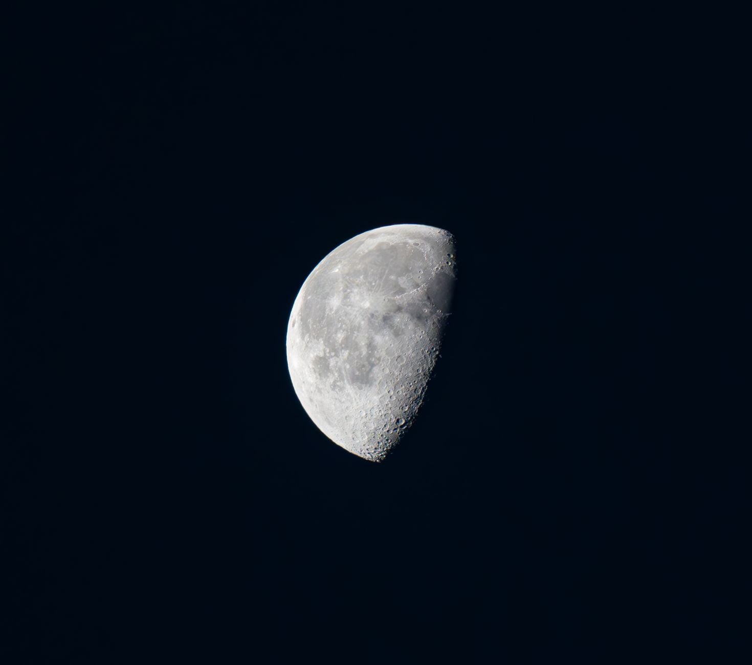 Stunning half moon captured in the clear night sky over Szklarska Poręba, Poland.