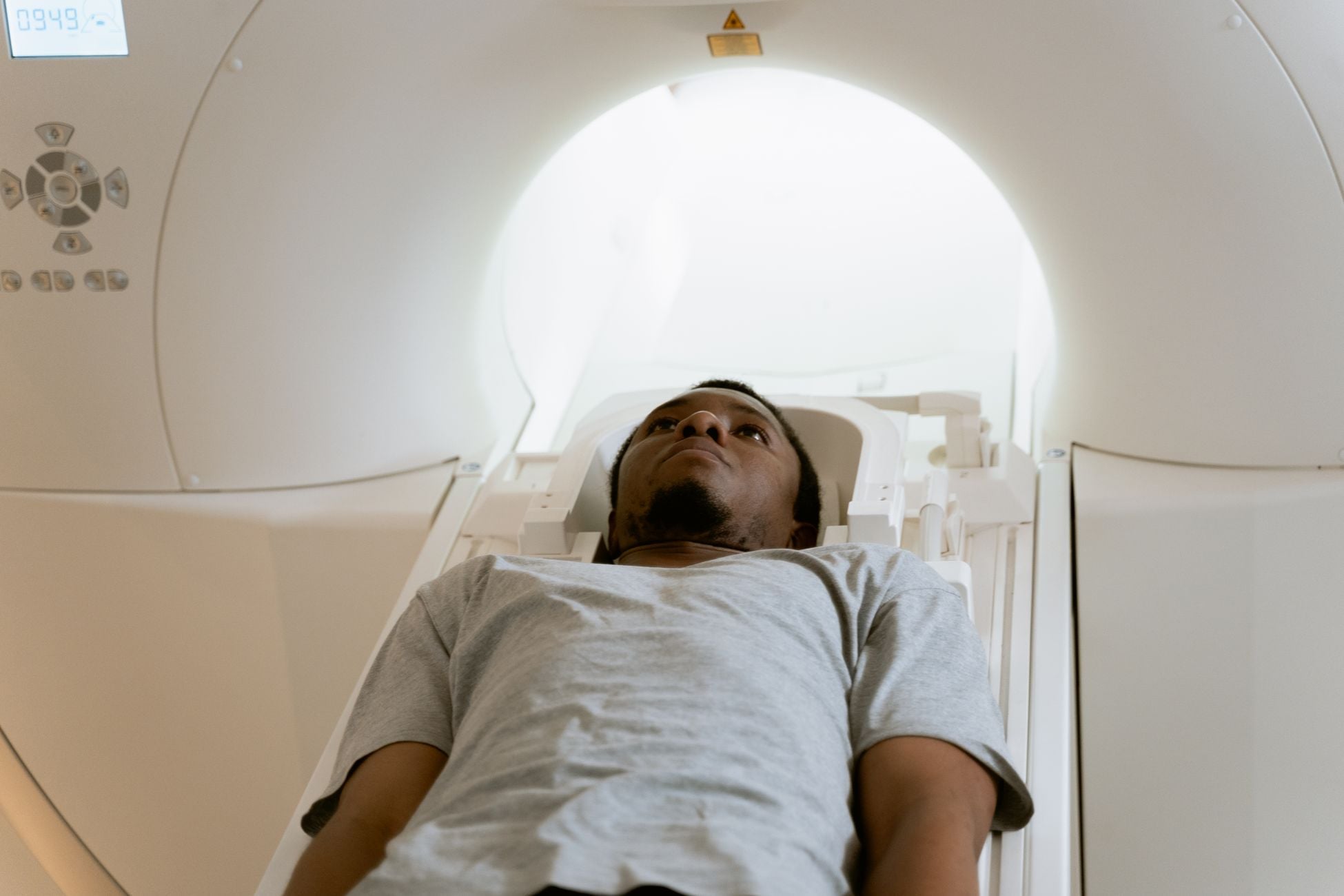 A patient laying inside an MRI machine during a medical scan at a healthcare facility.