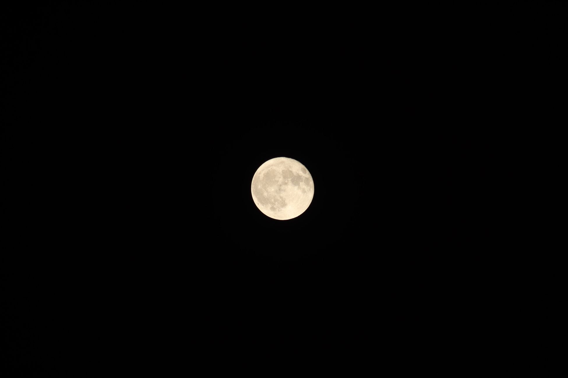 Stunning image of the full moon against a dark night sky, capturing its luminous glow.