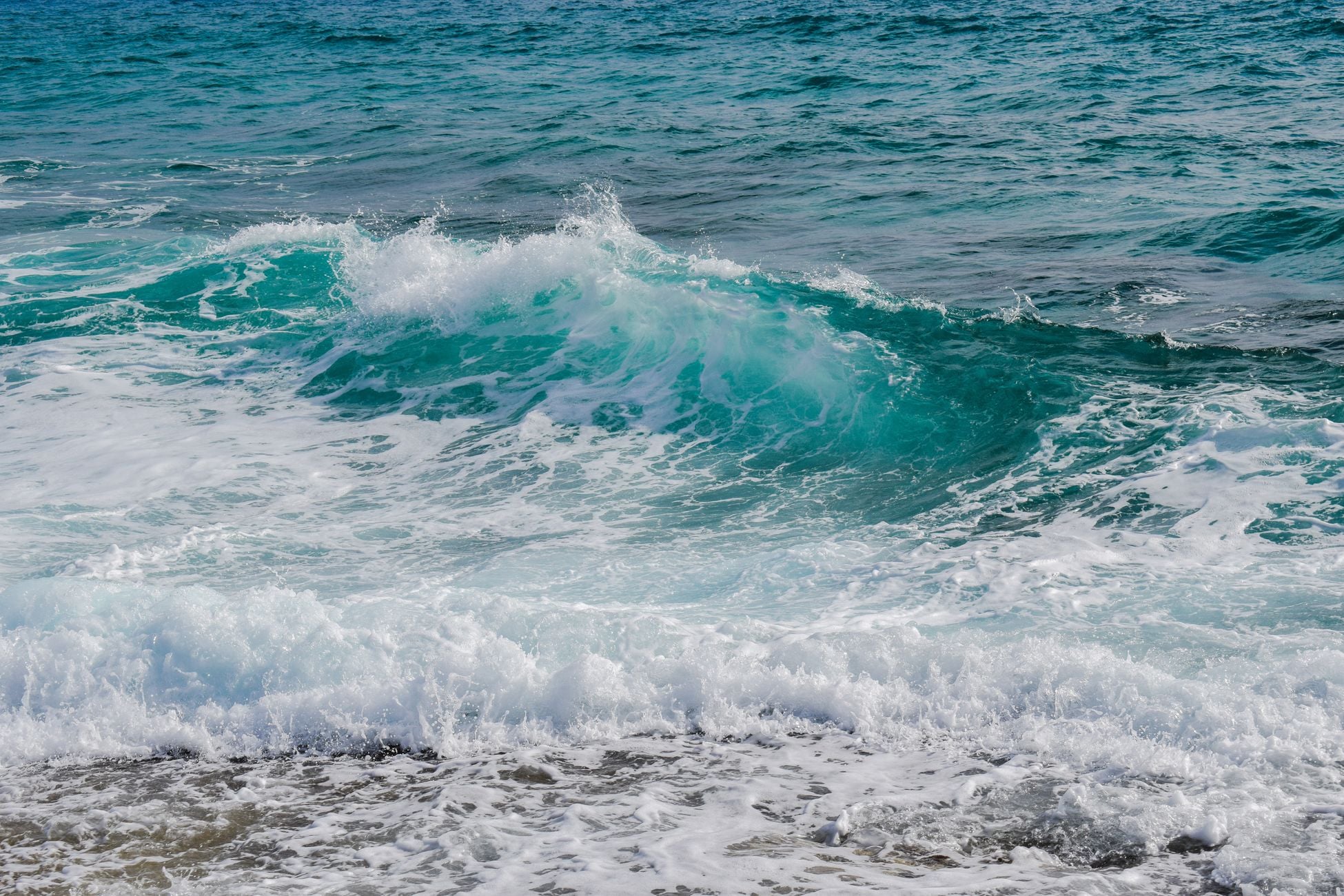 The tide rises twice a day because the ocean bulges on both sides of Earth at once — the near side pulled toward the moon, the far side, strangely, left behind as the planet is tugged out from under it