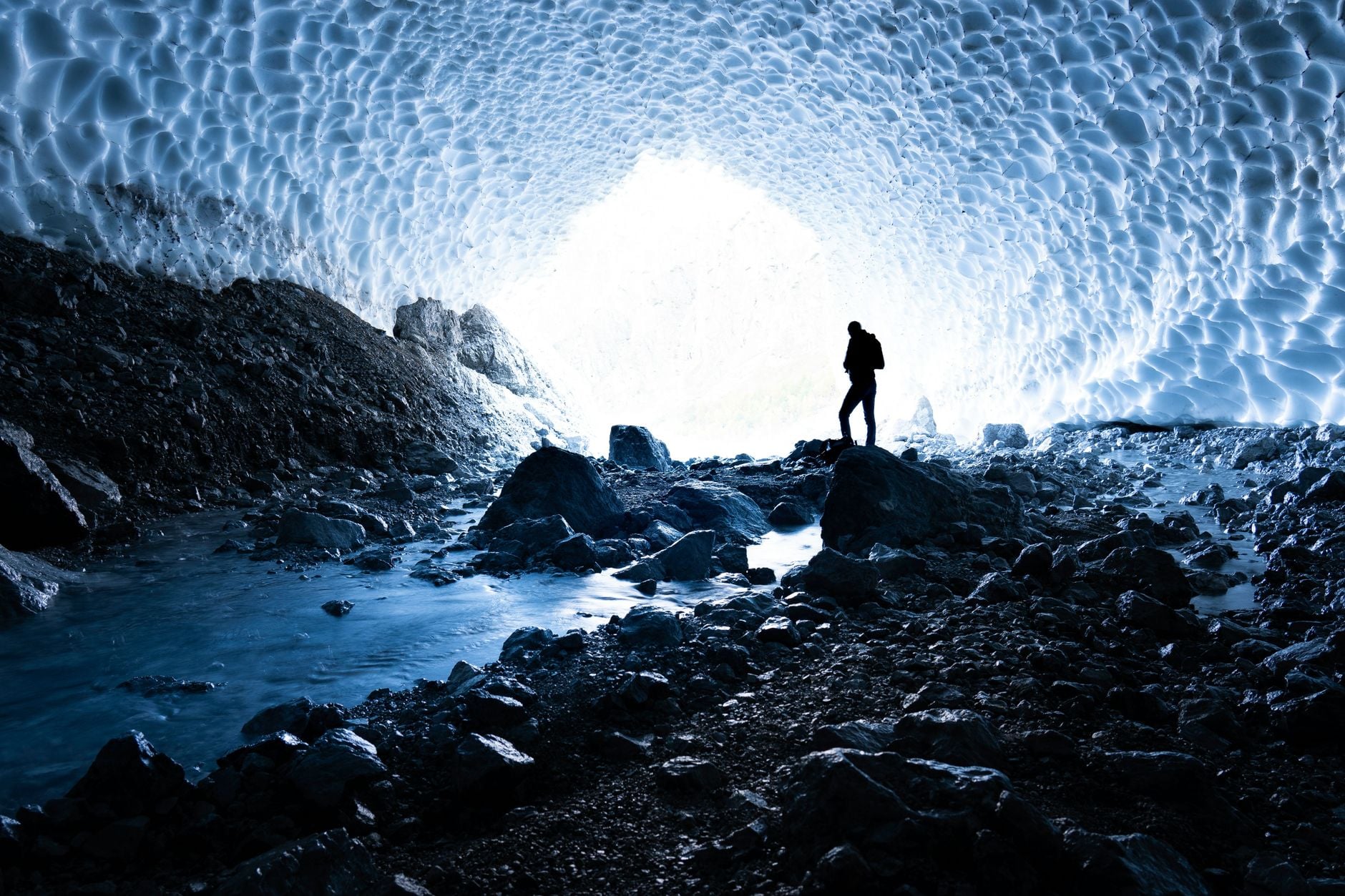 Two and a half kilometres beneath the Antarctic ice, a cubic kilometre of frozen water has been wired with 5,160 light sensors, turning the South Pole itself into a telescope that looks down through the entire planet to catch particles arriving from the other side of the sky