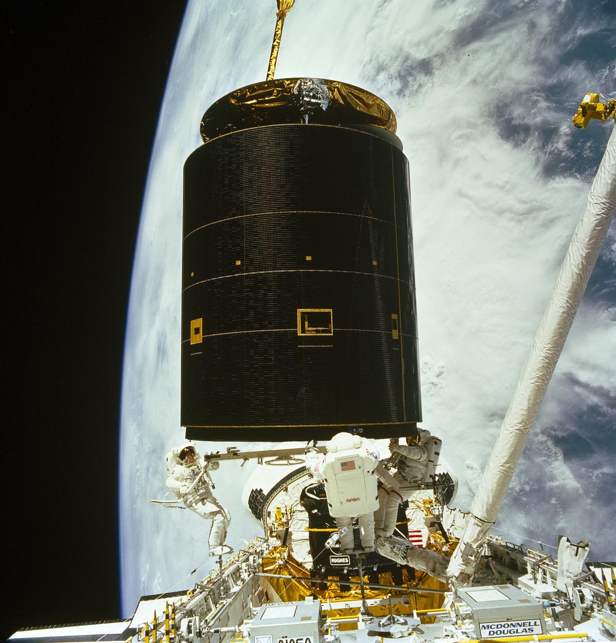 In May 1992, after two failed attempts to capture a 4.5-tonne communications satellite with a specially built tool, three astronauts left Endeavour together and grabbed the free-flying spacecraft with their gloved hands — the first, and still only, three-person spacewalk in history