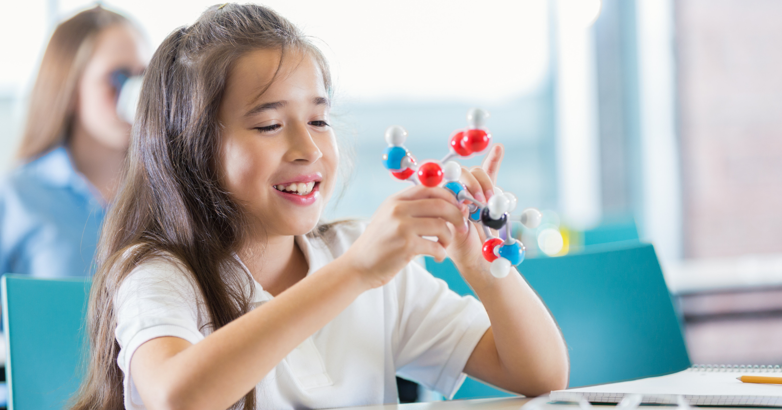 A fifth-grader in Kansas City clicked ball-and-stick atoms together in science class and asked her teacher if she'd made a real molecule — he photographed it, sent it to a chemistry professor, and at ten years old she became co-author of a published paper on a structure nobody had ever described