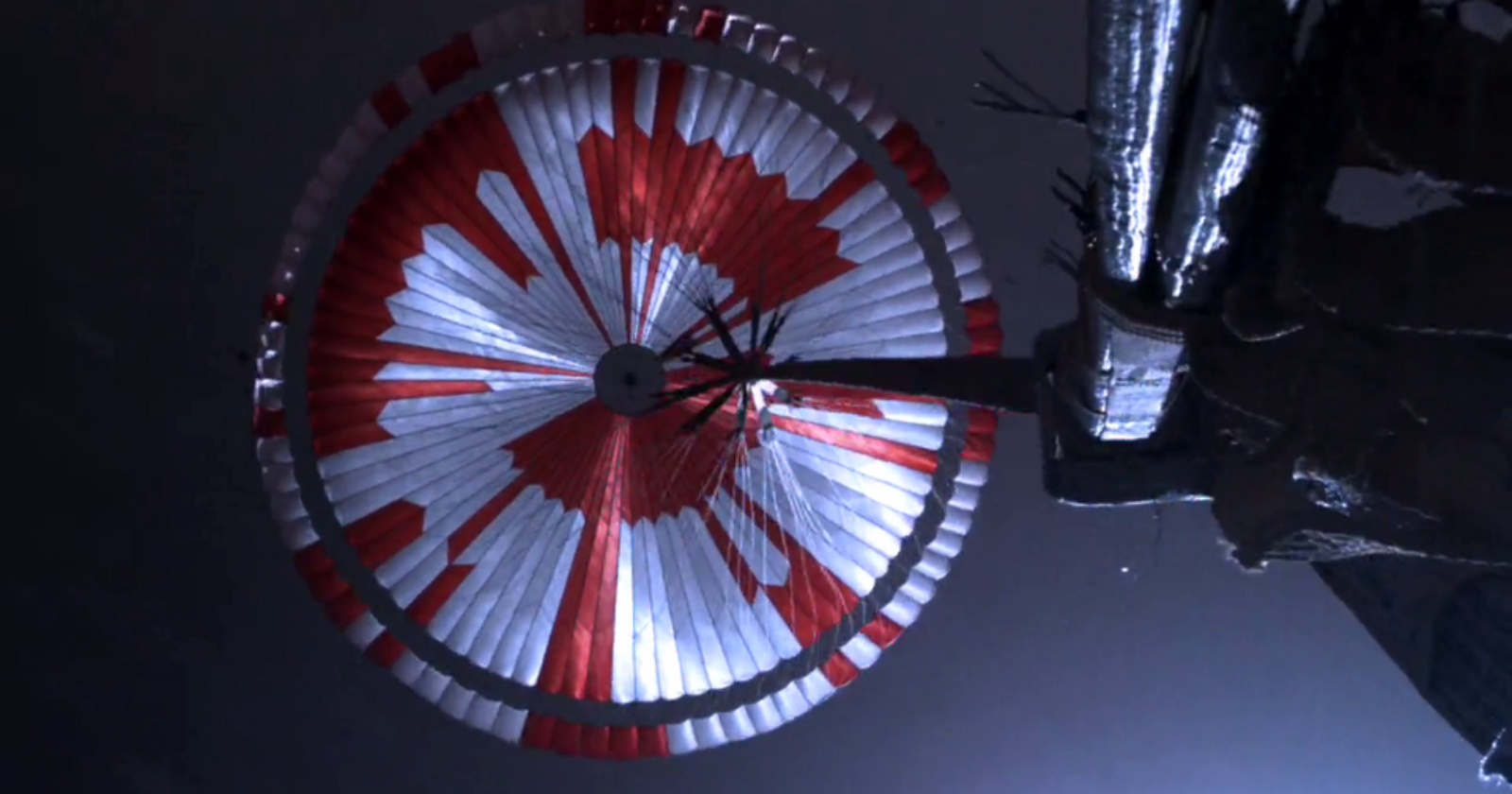 The stripes on Perseverance's parachute were mostly there so engineers could see how the canopy was oriented, but the pattern also hid a message in binary, and the internet decoded it within hours of the landing — a motto, and a set of coordinates pointing at a spot on Earth