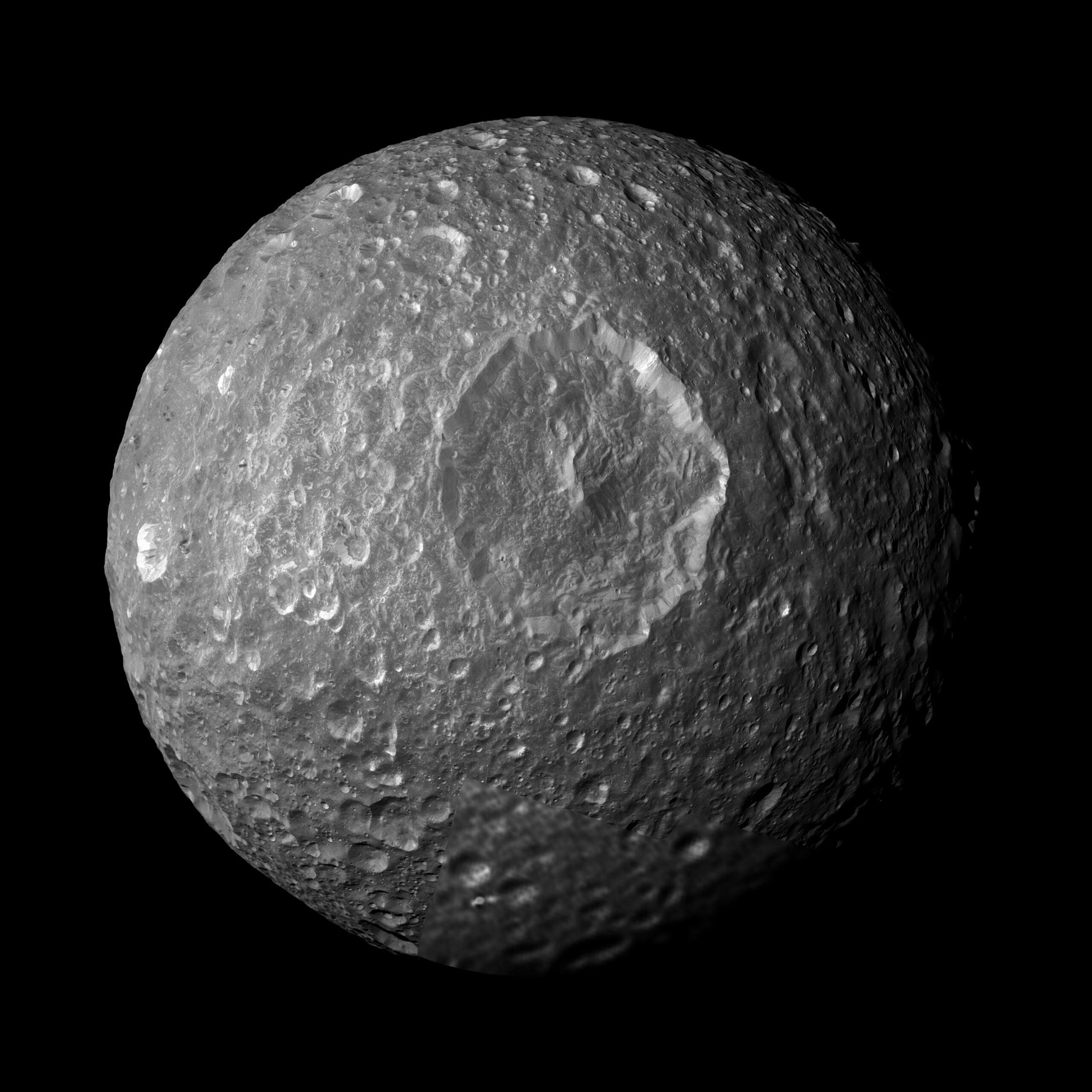 Saturn's moon Mimas looks like a dead, cratered rock — its surface is so inert that scientists assumed it was frozen solid — but in 2024 astronomers confirmed a global ocean hidden beneath the ice, formed just 5 to 15 million years ago