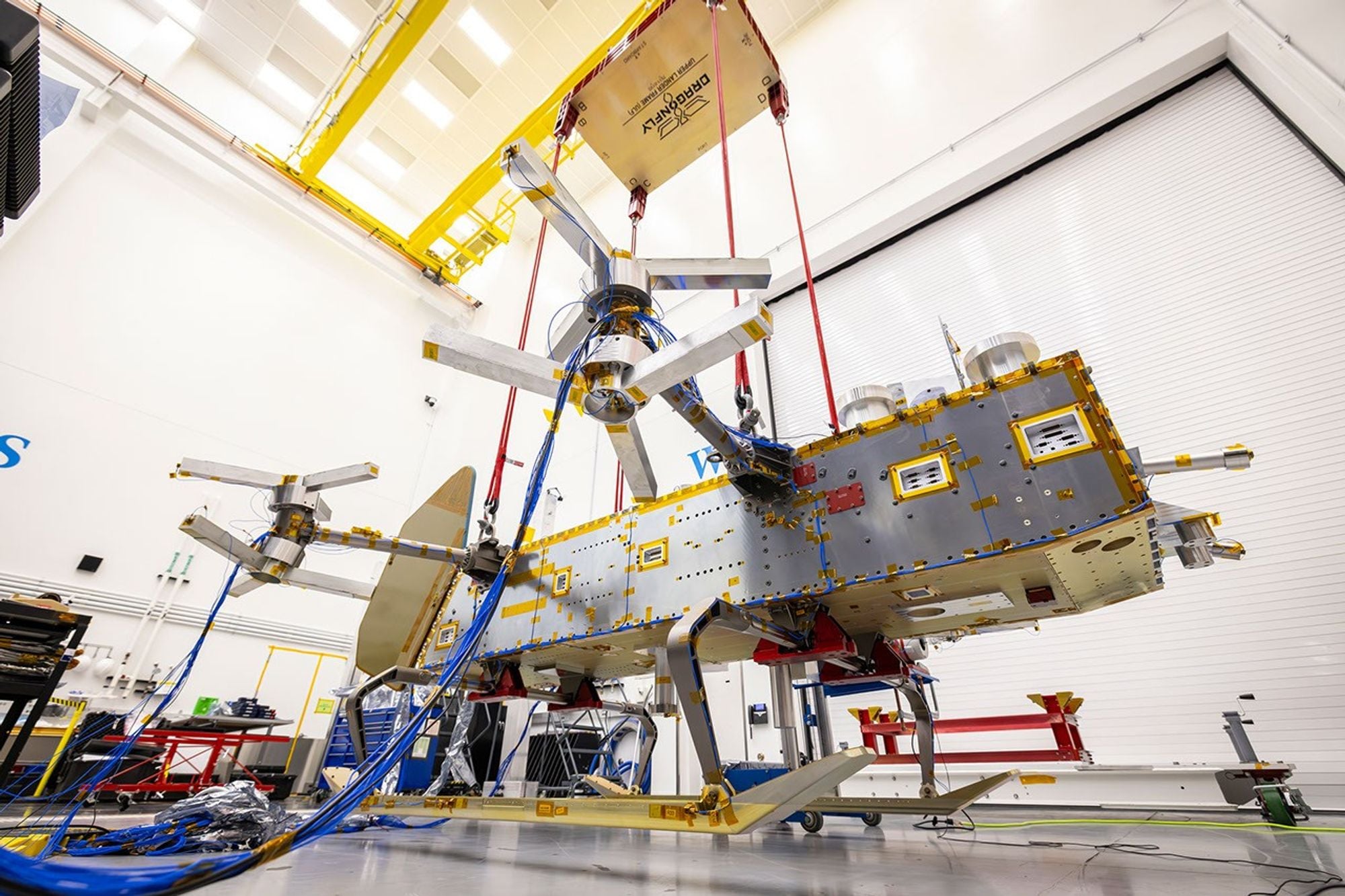 NASA is currently assembling a nuclear-powered octocopter in a Maryland cleanroom that is scheduled to reach Saturn's moon Titan in 2034. Titan's atmosphere is more than four times as dense as Earth's while its gravity is only about one-seventh as strong—conditions that make rotorcraft flight extraordinarily efficient, with ideal hover calculations requiring roughly 40 times less power than on Earth.