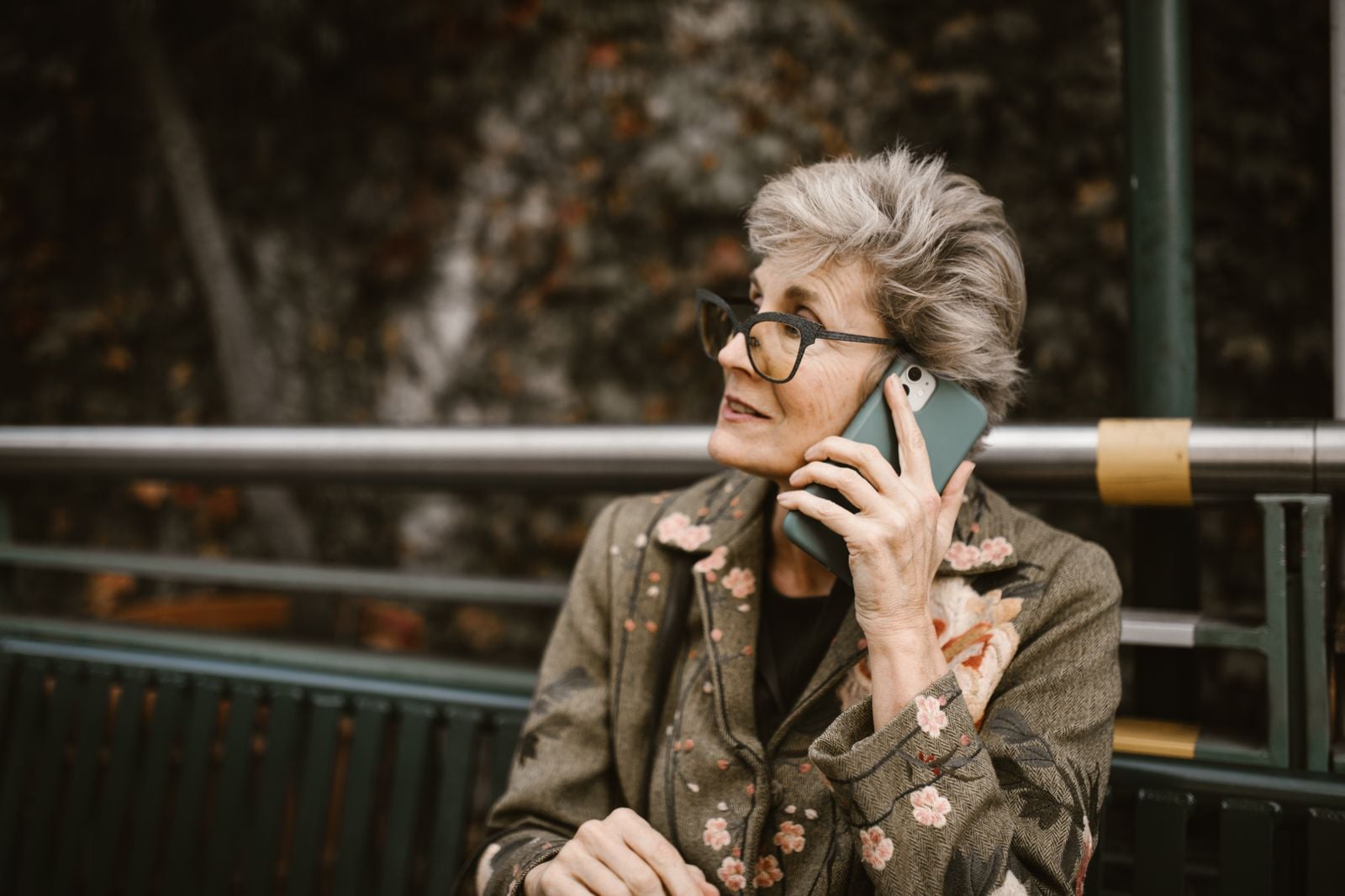 older woman phone kitchen
