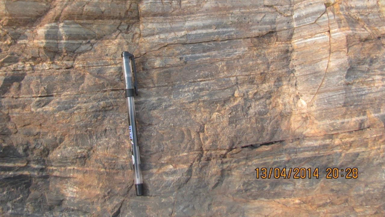 A carbon-rich rock from eastern India has been dated to 3.497 billion years using zircon crystals deposited alongside it. Its isotopic fingerprint points to microbial carbon fixation, making it—according to its discoverers—the oldest directly dated rock with a confirmed biosignature and evidence that life was converting inorganic carbon into organic matter while Earth’s continental crust was still assembling.
