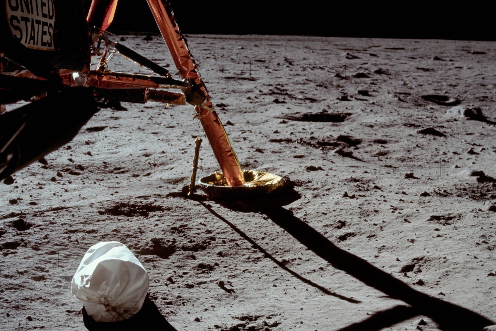 Across six Apollo landings, astronauts left a commonly cited 96 waste bags and containers on the Moon. Researchers have proposed retrieving one—not to clean up, but to discover whether any human microbes survived up to 57 years of lunar radiation, vacuum and extreme temperature swings.