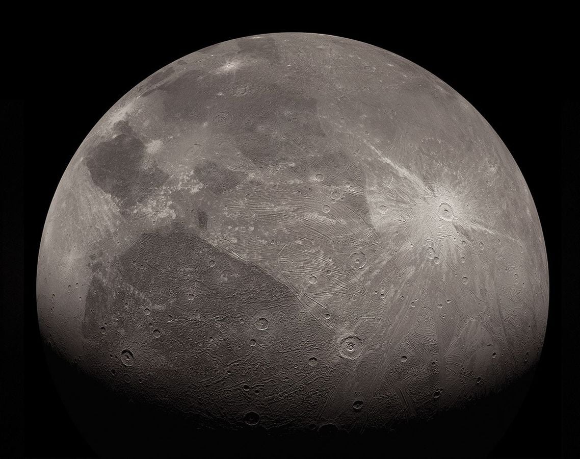 Ganymede is a moon, yet it is larger than the planet Mercury, may contain more water than exists on Earth's surface, and even generates its own magnetic field, making it less like a conventional moon than a full-sized world that happens to orbit Jupiter.