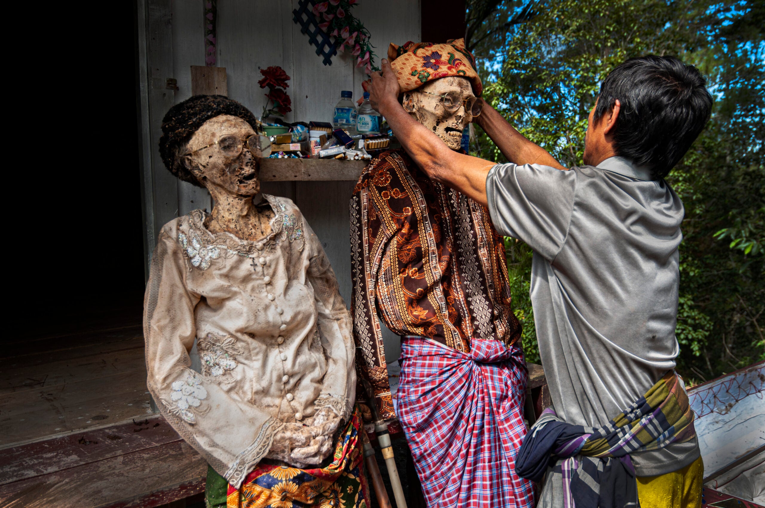In one Indonesian community the dead are not buried for weeks, months or even years, and are kept at home and cared for as if sleeping until the family can afford an elaborate funeral, a practice that reframes death as a slow departure rather than a single moment.