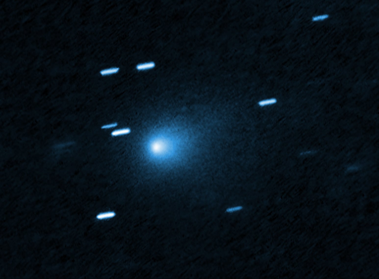 Hubble image of interstellar comet 3I/ATLAS with a teardrop-shaped dust cocoon.